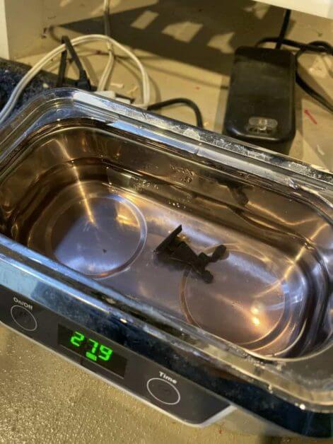 Ultrasonic cleaner used for stripping paint from plastic, resin, and metal miniatures after soaking.