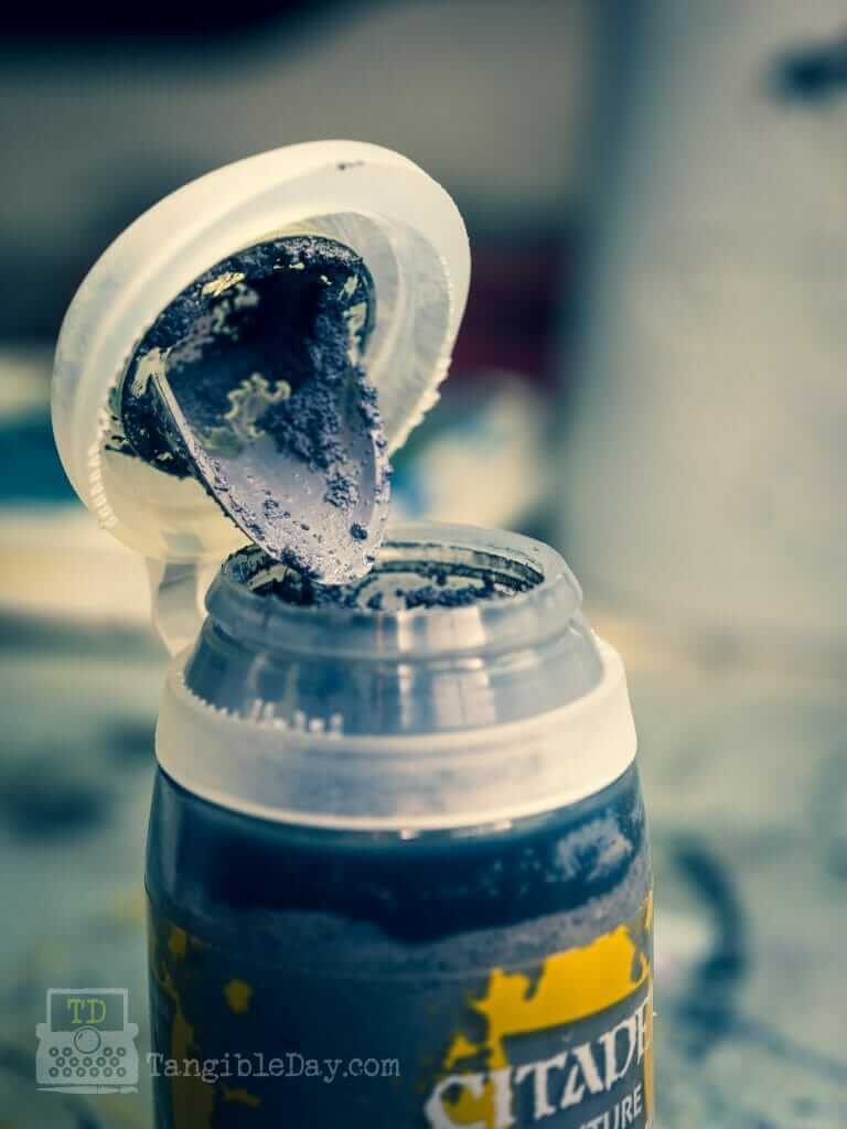 Open jar of Citadel Technical Astrogranite Debris showing the thick gritty texture paint used for miniature basing