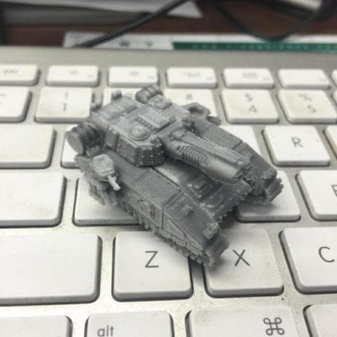 3D printed miniature tank for 40k epic size 10mm scale - Arenpi 3D printable files and marketplace for 3D printing miniatures and models - shadowsword tank printed and on keyboard