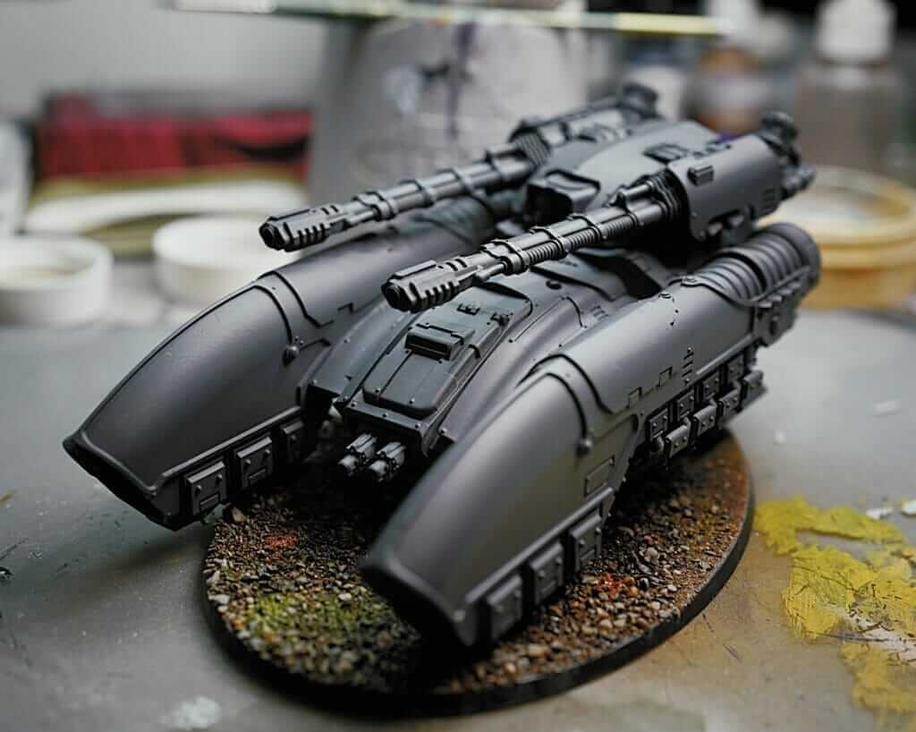 Primed sci-fi hover tank model on display with smooth surface prep