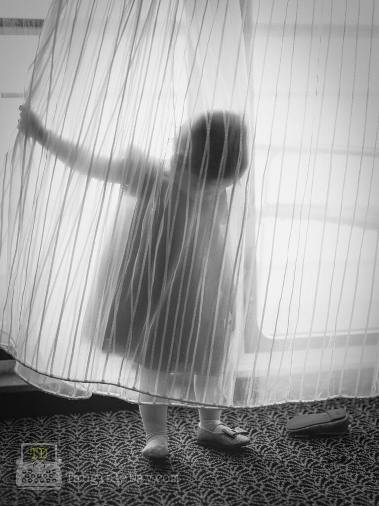 What is "Learned Helplessness"? Insights for Artists - A toddler girl looking for her shoe behind a curtain