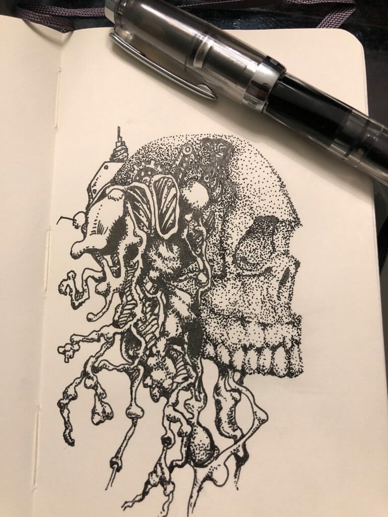 Skull doodle with blank ink in a notebook with white paper sheets