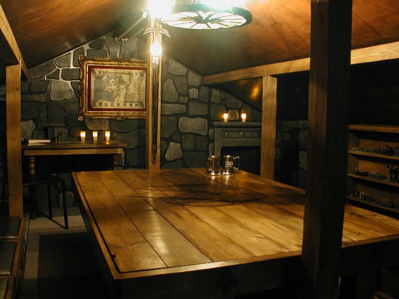 An immersive dark gaming room with a large table with lighting
