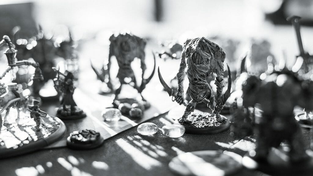 How Inflation and a Bad Economy Can Fuel Your Creative Writing - creativity and art during hard economic times - miniature wargame in progress in black and white photo