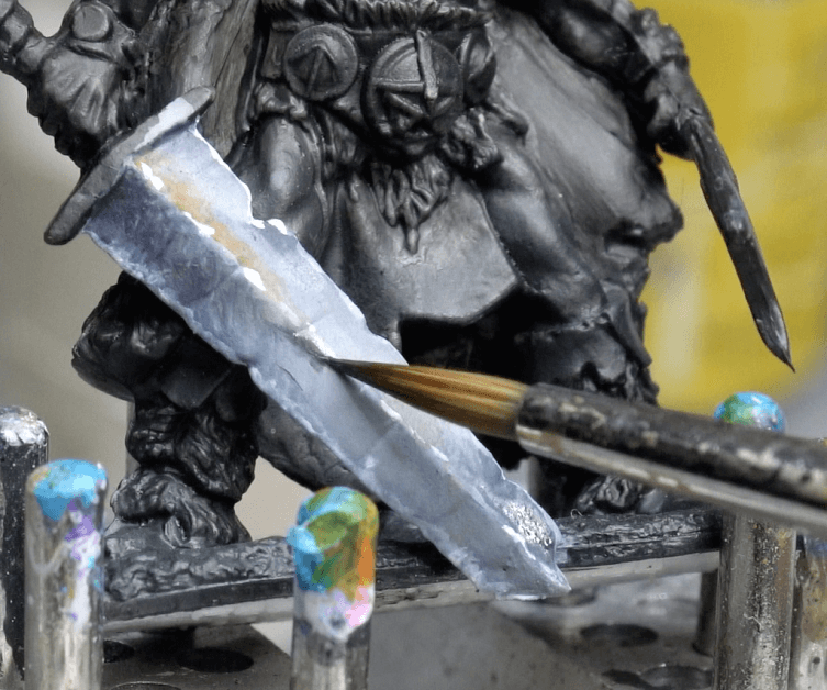 Zenithal Dry Brushing to "SlapChop" Paint Miniatures - edge higlighighlightinghting close up on a sword model