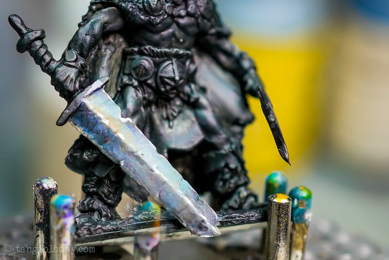 How to paint NMM power swords and effects - close up of a finished broadsword with various colors and tones