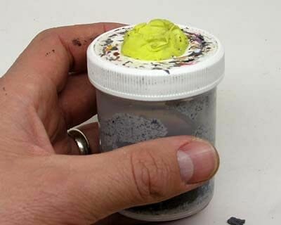 DIY miniature painting handle made from a bottle cap and adhesive putty