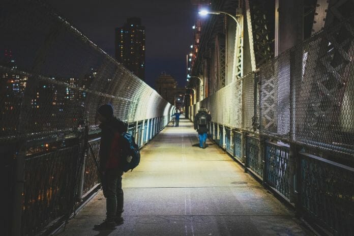Night photography - night time photography and how to take pictures at night - Night light photography and how to take pictures at night - what night photography settings - photographer standing on bridge to capture night time pics 
