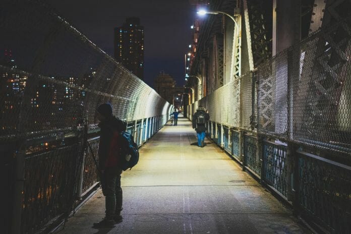 Night photography - night time photography and how to take pictures at night - Night light photography and how to take pictures at night - what night photography settings - photographer standing on bridge to capture night time pics