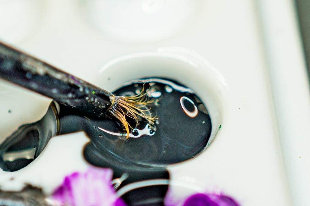 How to Paint Model Tanks (8 Basic Steps) - painting tanks - how to paint model tanks - close up photo of a brush dipped in black primer paint