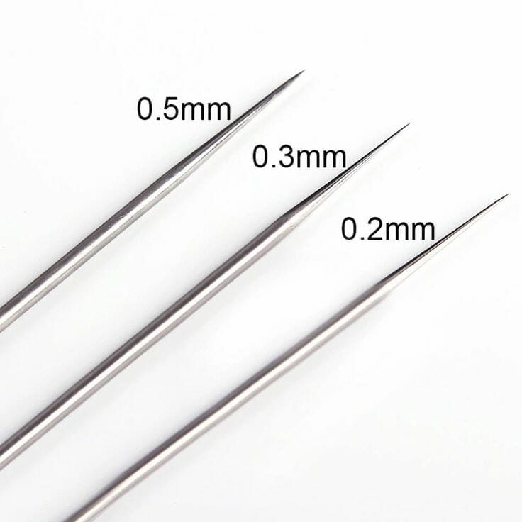 Comparison of airbrush needle sizes, showing 0.2mm, 0.3mm, and 0.5mm tips side by side.






