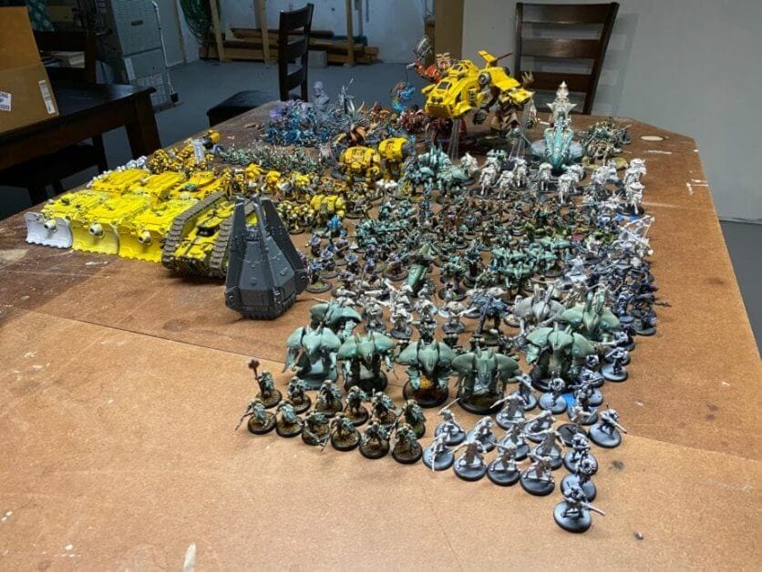 Miniatures, a lot of them, arrayed on a large tabletop