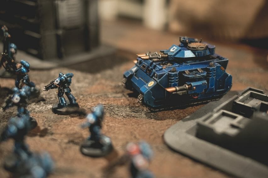 The History of Tabletop Wargaming - Miniature wargaming history through the ages, milestones and key points - Ultramarine space marine force close up on a tabletop predator tank