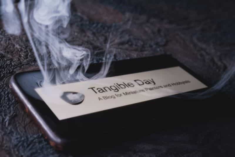 Smoking smartphone iphone on a tablet with my blog title tangible day on the face
