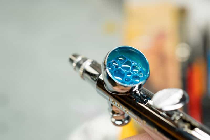 Airbrush paint blue in cup