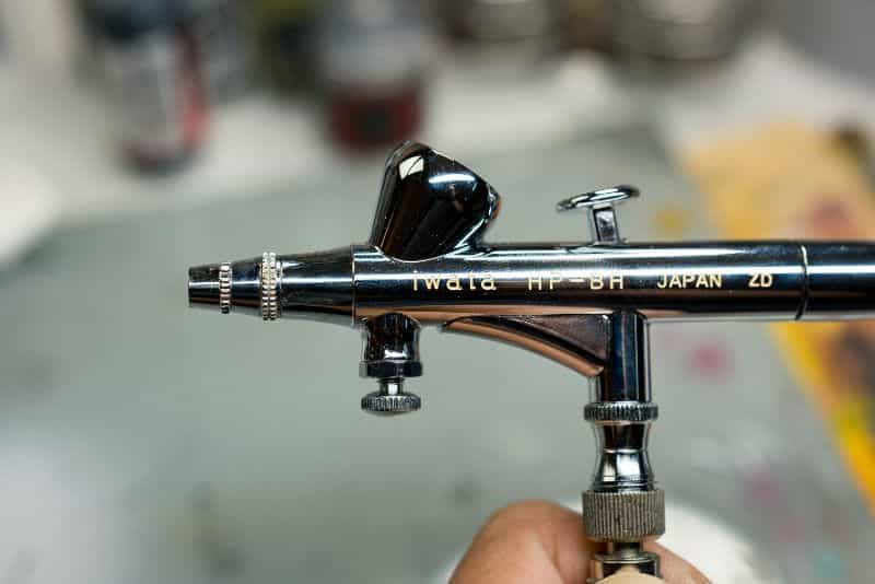 How to thin acrylic paint for airbrushes – how to thin paint for airbrushing miniatures and models –  What and how to thin hobby paint for your airbrush - side view airbrush gravity feed double action iwata - best thinner for hobby paint for airbrushes