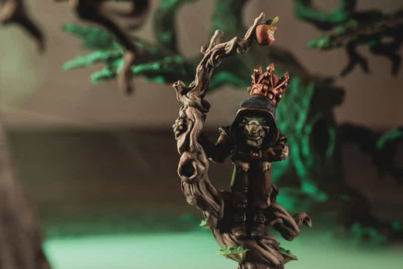 Miniature Paint Brush Care Tutorial - how to care for brushes for miniature painting - The king of nothing miniature from the Grymkin faction in the Warmachine Hordes miniature wargame. A stylized close up photo with an eerie green lighting effect with a hazy, smoke backdrop