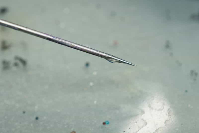 How to thin acrylic paint for airbrushes – how to thin paint for airbrushing miniatures and models – What and how to thin hobby paint for your airbrush - oil on needle tip close up