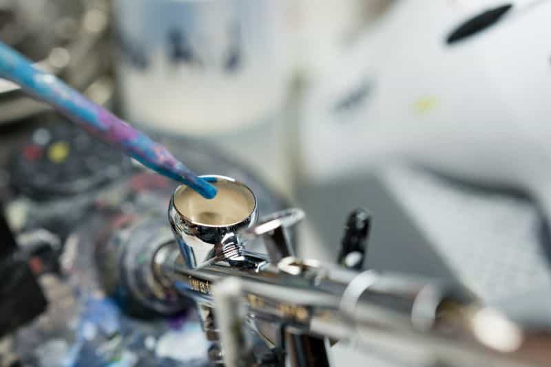 Reaper Vex airbrush review - eye dropping dispensing paint in the paint cup of iwata airbrush