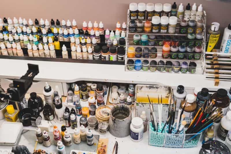 Hobby perfectionism solutions - my messy hobby desk with paint and brushes