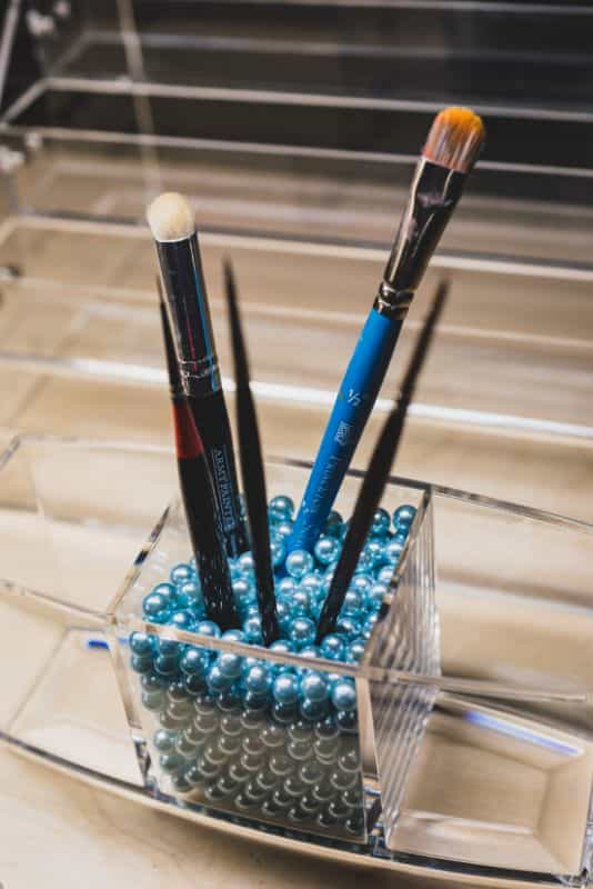 best brushes for painting miniatures standing in a holder