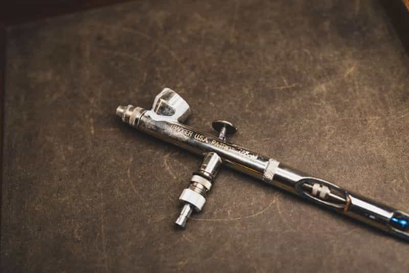 Badger Airbrushes: Best Beginner to Advanced Models for Painting Miniatures? - best badger airbrush for miniature painting - patriot 105 airbrush on leather background