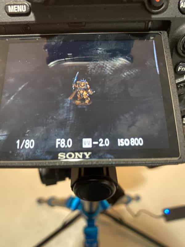 How to Photograph Miniatures with a Black Background (Guide) - how to capture miniature photos with pure black backdrops - infinite black backgrounds in miniature and model photography - guide for pure black background miniature photography -manual mode settings