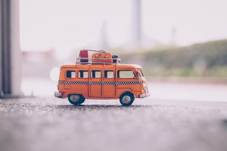 orange van die cast model on pavement - miniature hobby business ideas