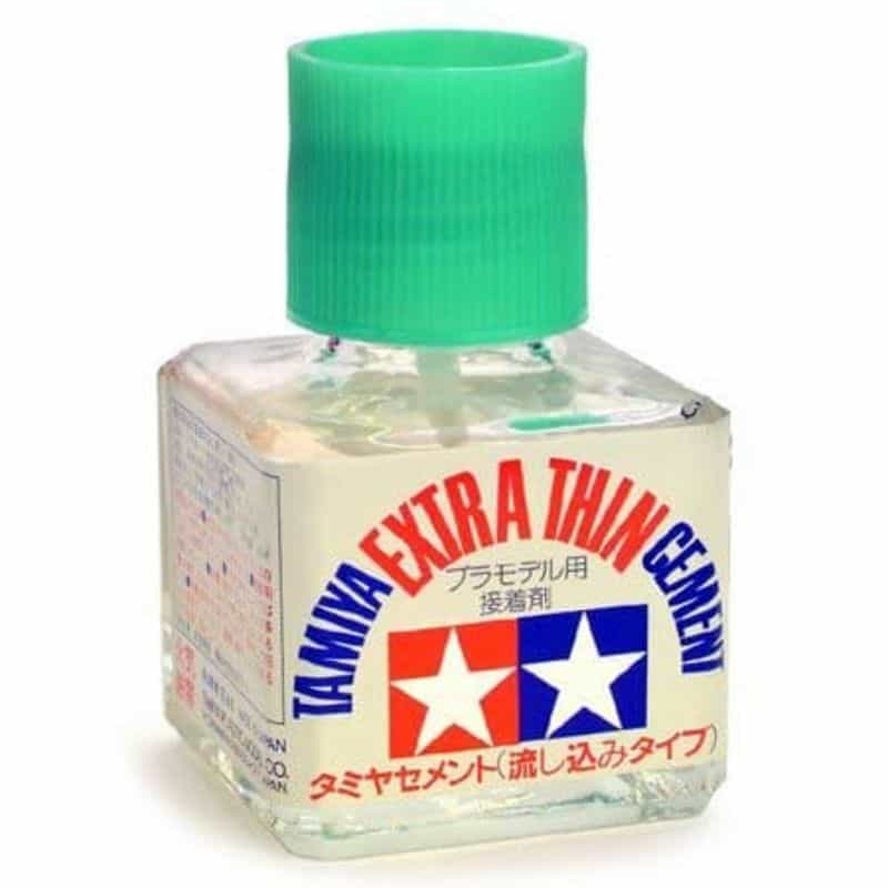 Tamiya Extra Thin plastic cement bottle with brush applicator for fine detail model assembly.