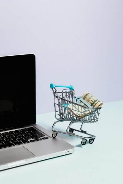 shopping cart with money on top of a laptop - how money ruins a hobby - why paint miniatures for money 