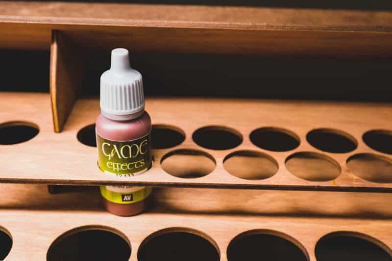 Understanding Acrylic Paint for Miniature Hobbies: Uses, Types, and Best Picks (Guide) - Vallejo paint bottle in a storage rack stand alone