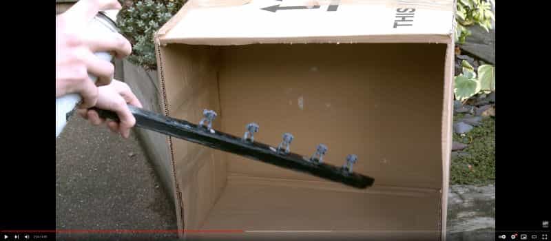 Video showing how to prime miniatures with an aerosol rattle can outside in a cardboard box