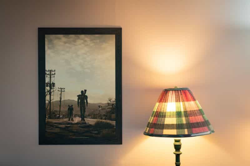 Fallout 3 metal poster on wall with warm lamp glow nearby