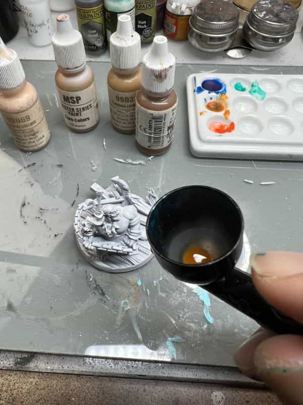 Badger Airbrushes: Best Beginner to Advanced Models for Painting Miniatures? - best badger airbrush for miniature painting - Brown paint in paint cup painting model