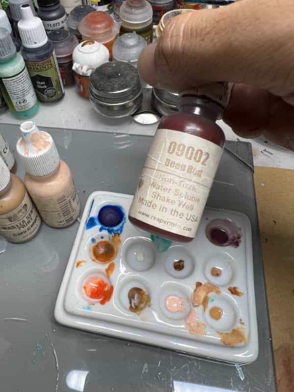 Understanding Acrylic Paint for Miniature Hobbies: Uses, Types, and Best Picks (Guide) - Reaper Master Series paint in a bottle close up label worn out