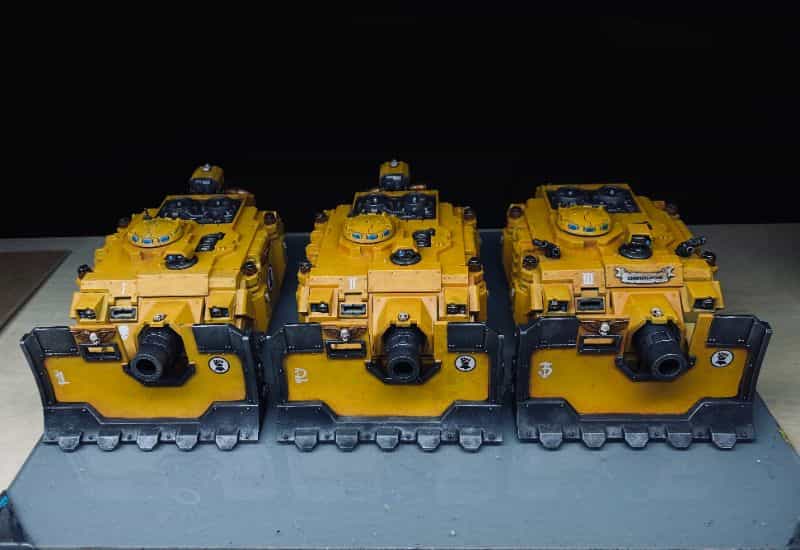 3 Ways to Stay Motivated Painting Miniatures - three vindicator tanks on my painting table