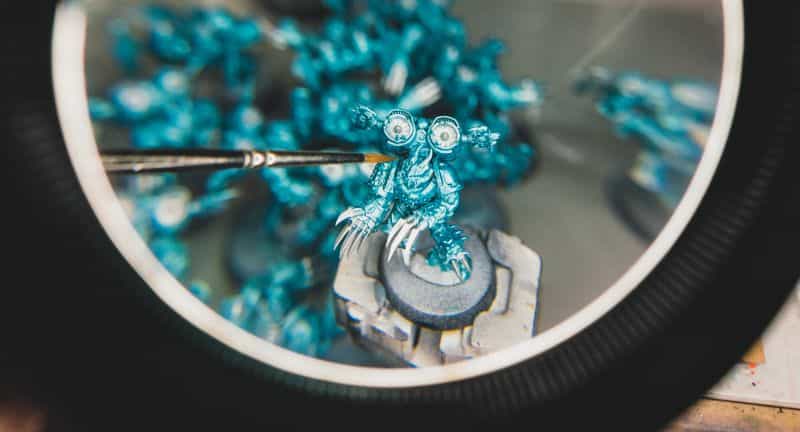 Painting a miniature view through a magnifying glass