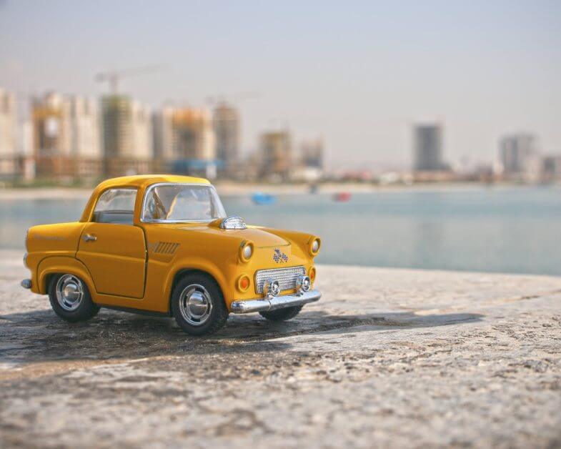 selective focus photography of yellow car toy - a model car 