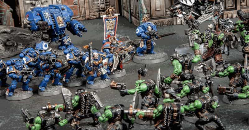 Best tabletop miniature games - Miniature wargaming - what is tabletop wargaming - popular wargames with miniatures - warhammer 40k game with orks and space marines ultramarines