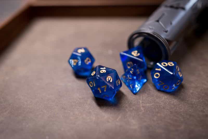 SMONEX Dice Tower Review - Spilled blue acrylic dice on a leather dice tray