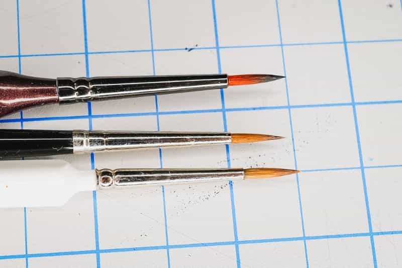 How to Paint Plastic Miniatures (Step-by-Step) - 3 paint brushes side by side all pointed round comparison photo