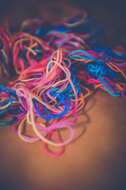 blue and red thread on brown textile