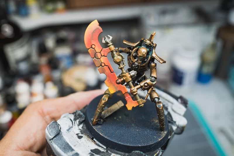 Understanding Acrylic Paint for Miniature Hobbies: Uses, Types, and Best Picks (Guide) - What is acrylic paint, its uses, and best types - a gradient of red and orange on a power weapon for Necrons warhammer wargame model