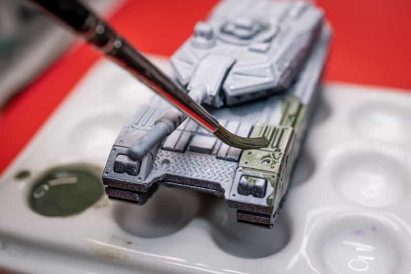 How to Paint Model Tanks (8 Basic Steps) - painting tanks - how to paint model tanks - Close up photo of green glaze applied to a model's surface.