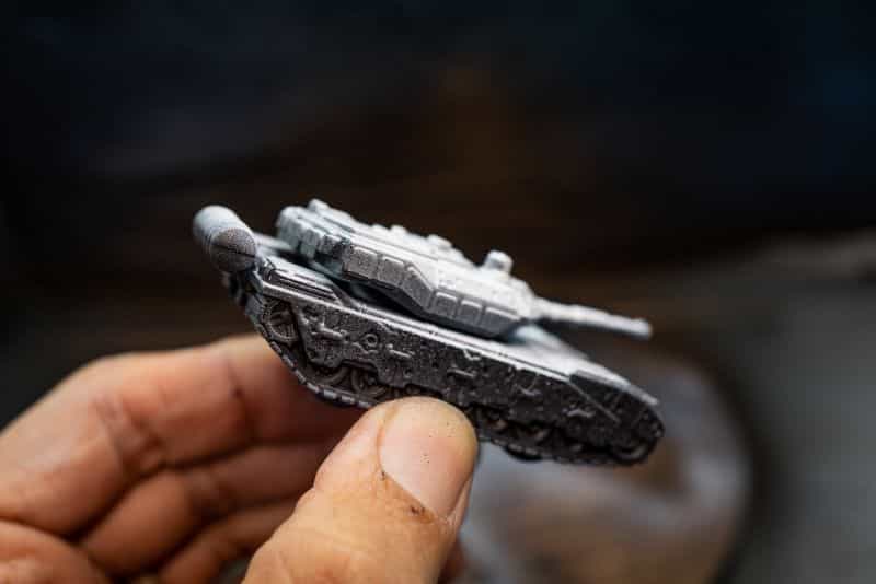 How to Paint Model Tanks (8 Basic Steps) - painting tanks - how to paint model tanks - holding the primed model and a side view photo