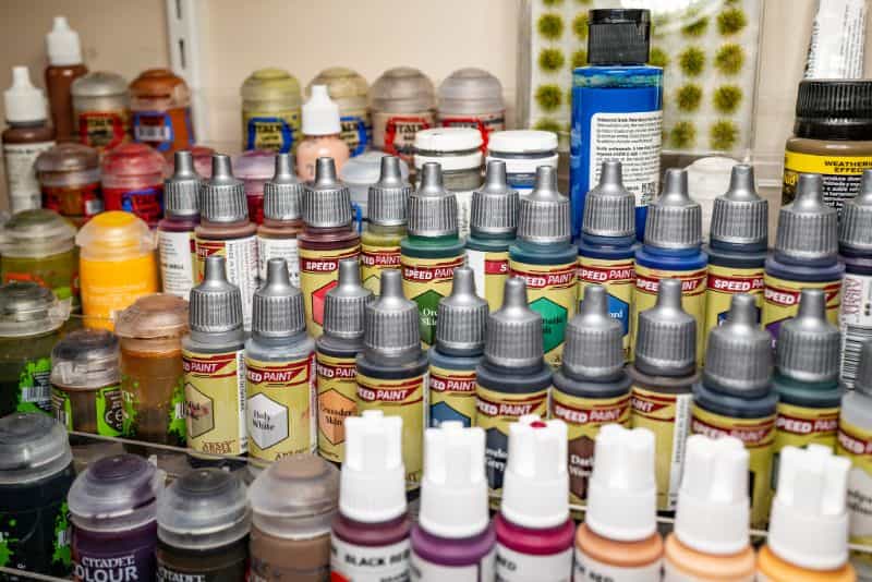 Best Kind of Paint for Miniature Painting? - acrylic paint, oil paints, scale modeling, painting miniatures - Rows of colorful hobby paint on paint rack