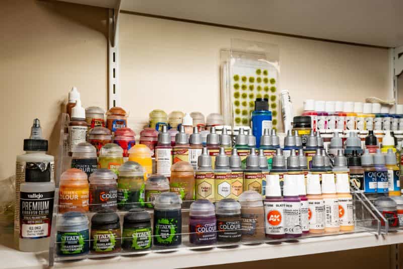 Best Kind of Paint for Miniature Painting? - acrylic paint, oil paints, scale modeling, painting miniatures - Hobby acrylic paints in a clear organizer rack display