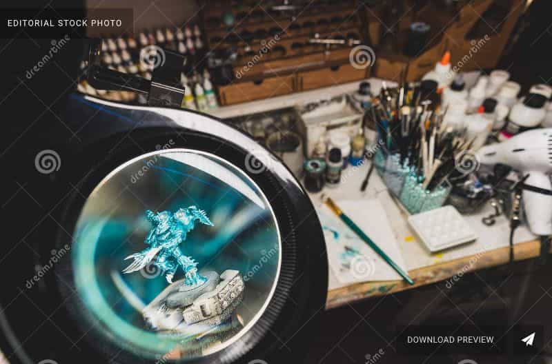 Overcoming fear as a new stock photographer - fear of stock photography - miniature photography starting tips - magnifying glass with enlarged image of warhammer alpha legion space marine