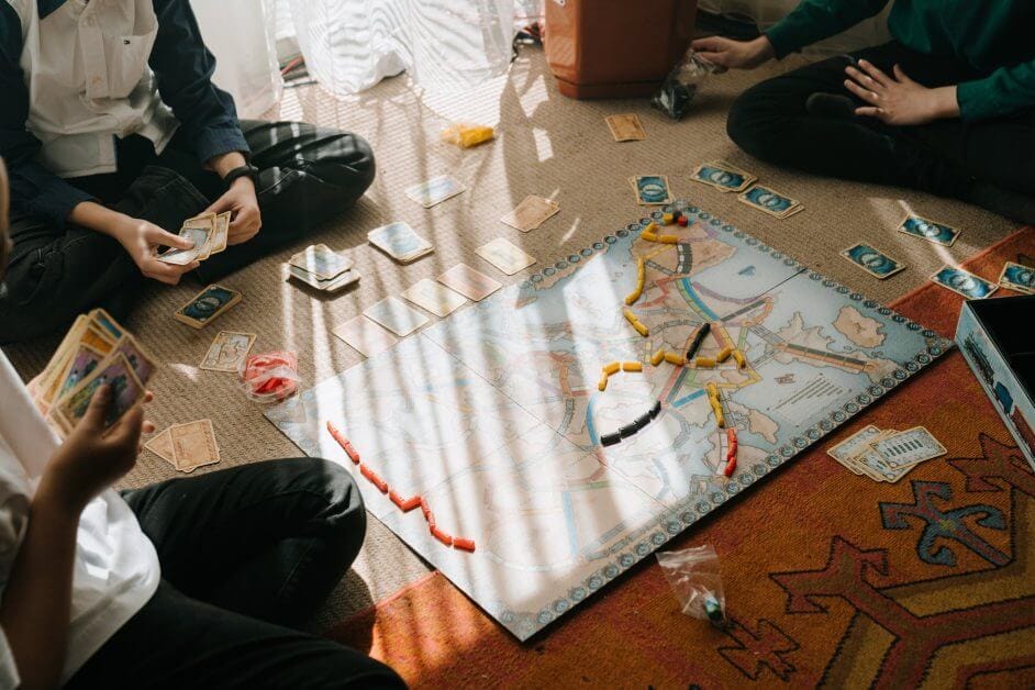 Overcoming Fear as a Miniature Stock Photographer - person in black pants sitting on floor playing board game