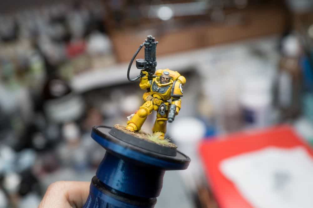 Best Airbrush Compressor for Models - best air compressor for airbrushing miniatures and models - Imperial fist warhammer 40k space marine on a painting handle
